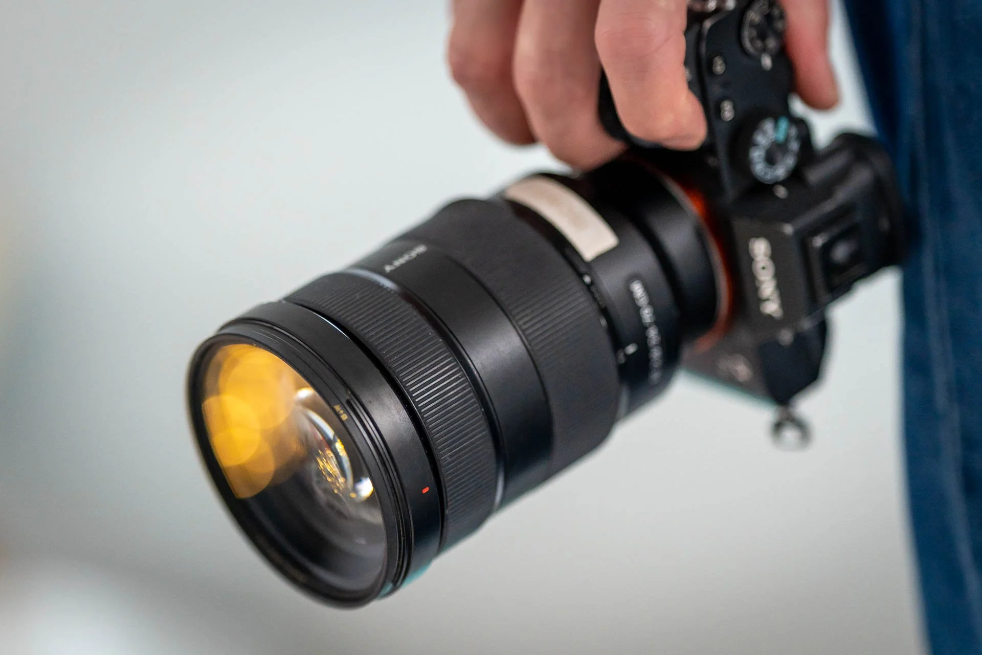 A close-up of a handheld camera fitted with a zoom lens.