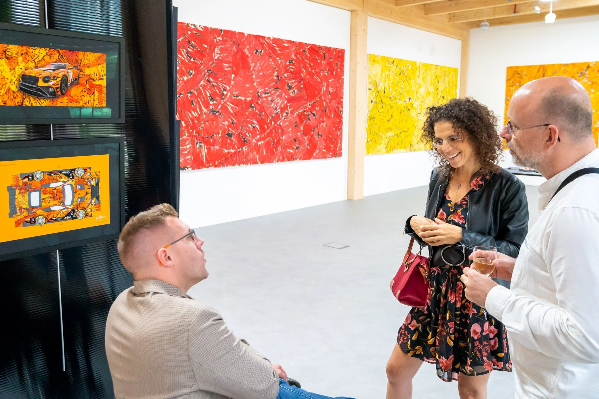 Visitors gather around a man in a wheelchair during the opening of the BXL ART NFT Gallery.