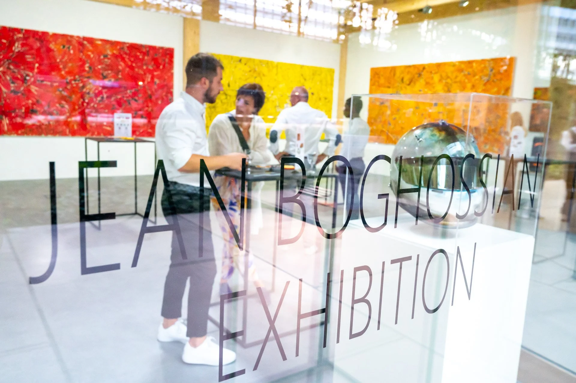 A visitor looking at a sculpture in an art gallery during the Jean Bogoisson exhibition.