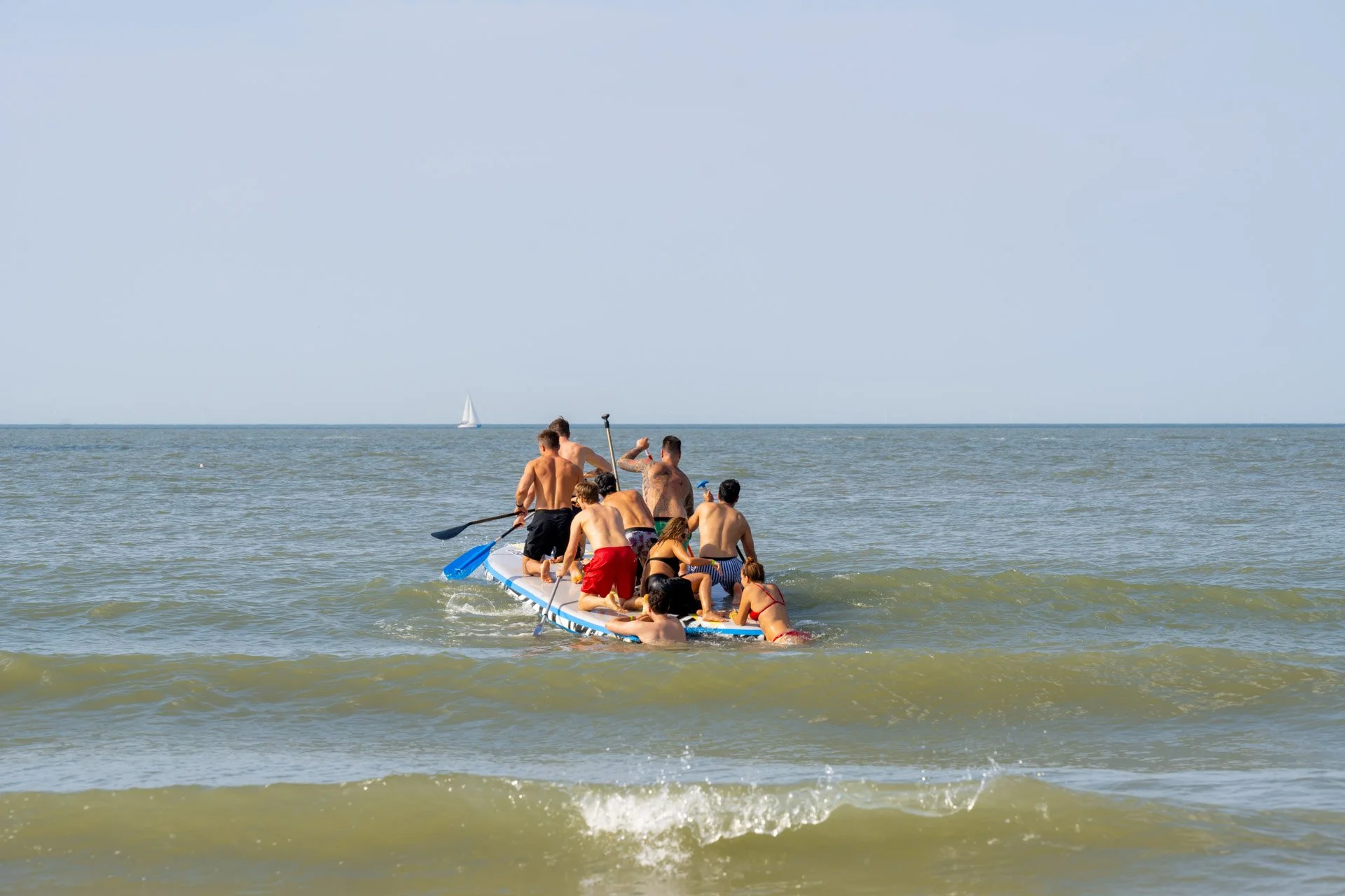 A group of participants on a boat at sea during a team-building activity on the coast.